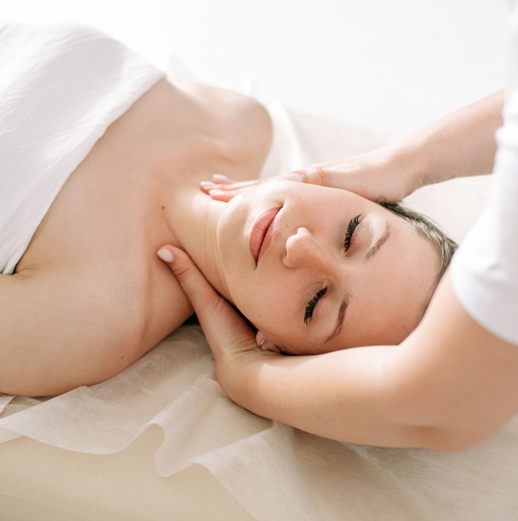 A serene spa treatment capturing a woman receiving a relaxing massage, symbolizing therapeutic wellness.